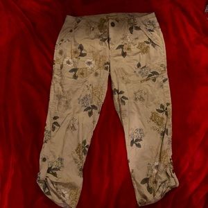 Cream pants with flowers on them.